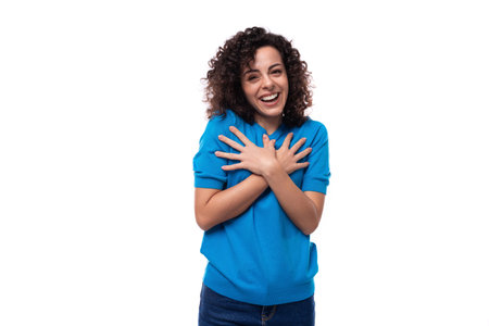 a young woman with a curly hairstyle above her shoulders feels joy and surprise