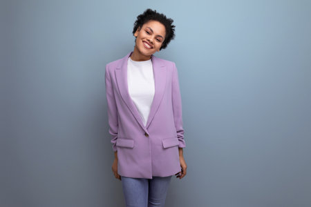 young successful hispanic brunette leader woman dressed in jacket on studio background with copy spaceの写真素材