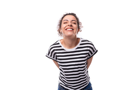 young dreamy well-groomed curly woman with black hair in a summer striped t-shirt