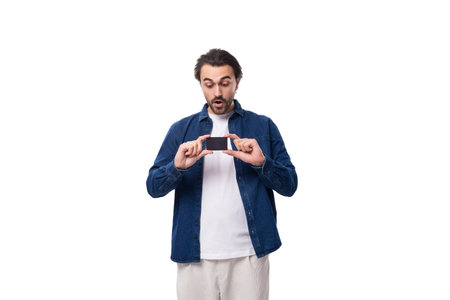 portrait of young european brutal brunette man with cool haircut holding plastic card mockup with mockupの写真素材
