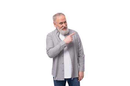 handsome funny gray-haired elderly man with a beard and mustache in a plaid shirt on a white background with copy spaceの写真素材