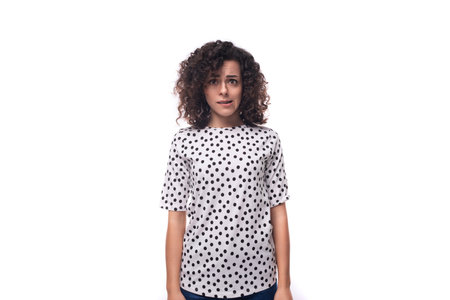 charming young brunette curly woman dressed in pea summer blouseの写真素材