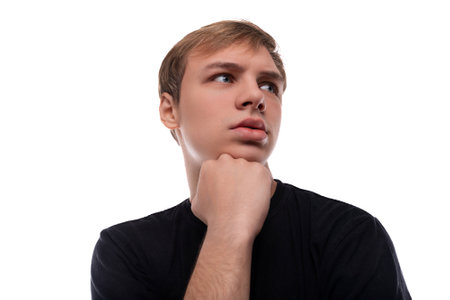 Headshot portrait of a smart blond teenage guy against a background with copy space