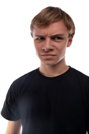 Confused teenager guy with blond hair furrowed his eyebrows