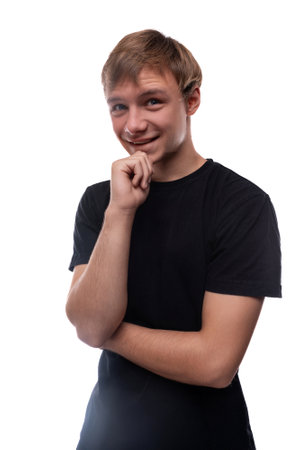 European blond teenager boy dressed in a black T-shirt smiling and happyの写真素材