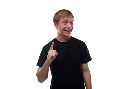 Portrait of a European handsome blond teenager guy in a black T-shirt