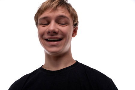 Smiling young man with blond hair on a white backgroundの写真素材