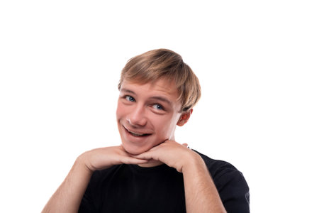 Headshot portrait of a blond Caucasian guy with blond hair dressed in a black T-shirtの写真素材
