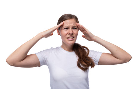 Smart young woman with straight brown hair generates ideas in her headの写真素材