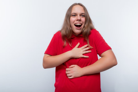 Funny girl with brown hair laughs loudlyの写真素材