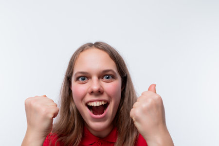 A lucky girl with brown hair rejoices at successの写真素材