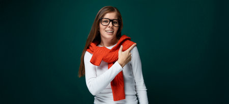 European young woman pointing with hand towards advertisement, business conceptの写真素材