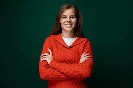 Cute young woman with brown hair wearing a red knitted sweater