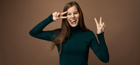 Successful 30 year old business woman with brown eyes wearing a green turtleneck on a brown backgroundの写真素材