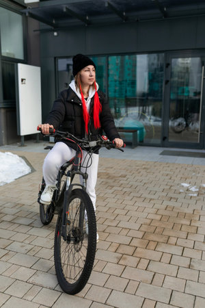 A woman took a rented bicycle with her outside in winter