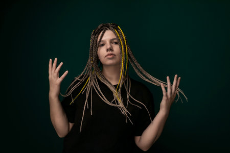 Woman With Dreadlocks in Front of Green Backgroundの写真素材