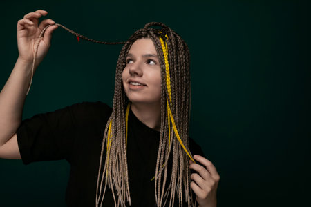 Woman Holding Long Dreadlocks in the Airの写真素材