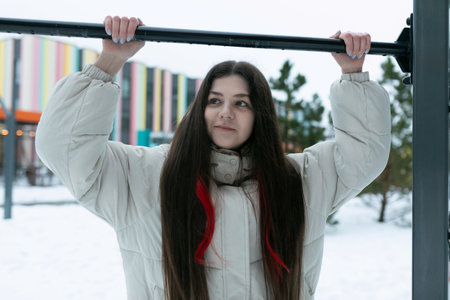 Woman With Long Hair Holding Onto a Poleの写真素材