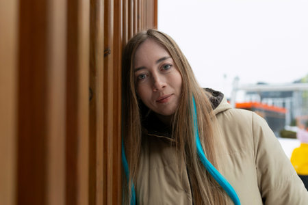 Woman With Blue Hair Leaning Against Wallの写真素材