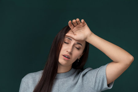 Woman Holding Her Head in Her Handsの写真素材