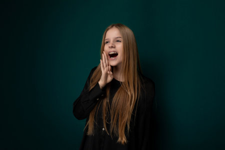 Woman Standing in Front of Green Wallの写真素材