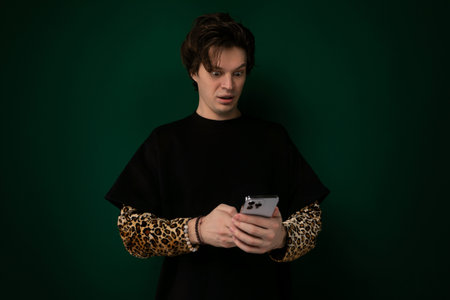 Man in Black Shirt Holding Cell Phone
