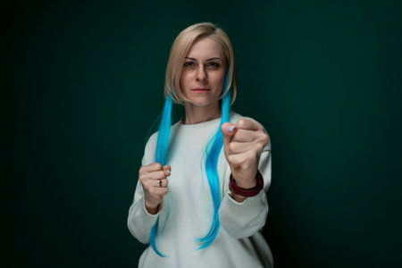 Woman With Long Blue Hair Holding a Pair of Scissors