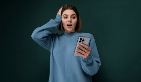 Woman in a Blue Sweater Holding a Cell Phone
