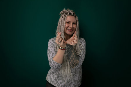 Woman With Dreadlocks in Front of Green Backgroundの写真素材