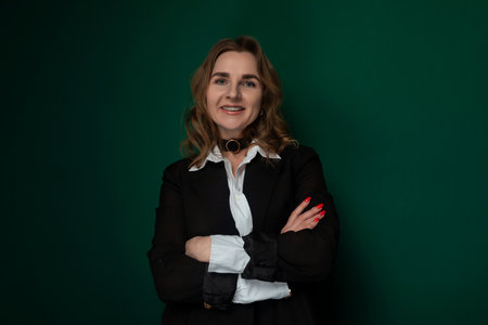 Woman Crossing Arms in Front of Green Wallの写真素材