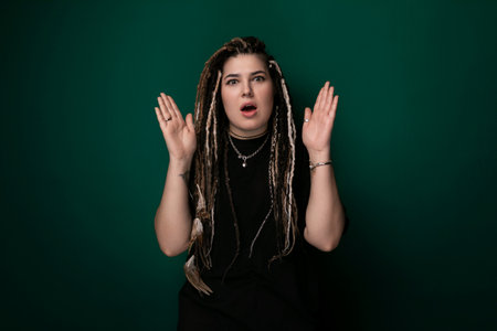Woman With Dreadlocks Standing In Front Of Green Background