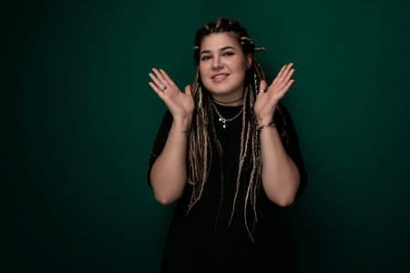 Woman With Dreadlocks Standing Against Green Background