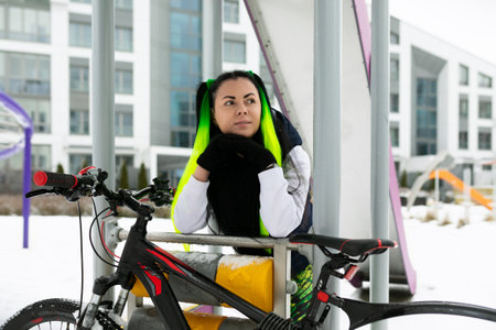 Woman Sitting on Bench Next to Bike