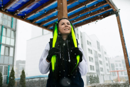 Woman in Black Jacket Holding Yellow and Blue Umbrella