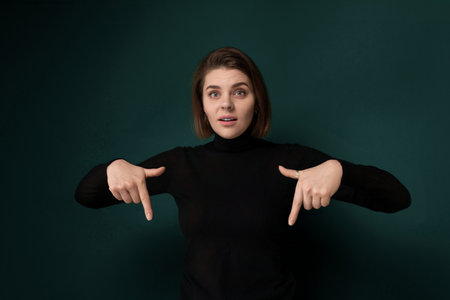 Woman in Black Shirt Pointing at Somethingの写真素材