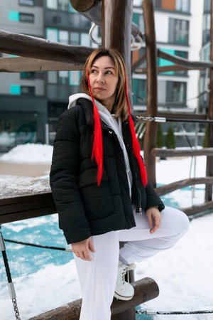 A woman walks in a complex for children on the street in winterの写真素材