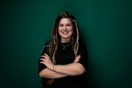 Woman With Dreadlocks Standing in Front of Green Wall
