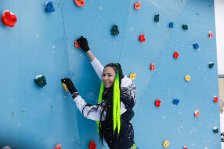 Woman Climbing Up Climbing Wallの写真素材
