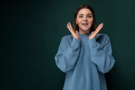 Woman in Blue Sweater Holding Hands Upの写真素材