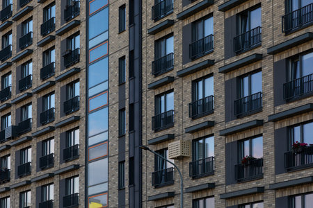 Modern high-rise apartment buildings in a residential area showcasing diverse window styles and...