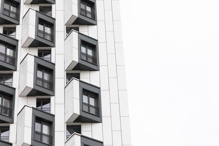 Modern high-rise apartment buildings with distinctive balconies in a residential area showcasing...