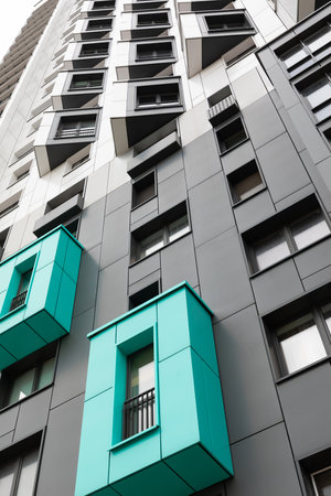 Modern high-rise apartment buildings in an urban residential area showcasing distinctive architectural featuresの写真素材