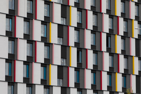 Colorful high-rise residential building in an urban area featuring modern architecture and distinct window patternsの写真素材