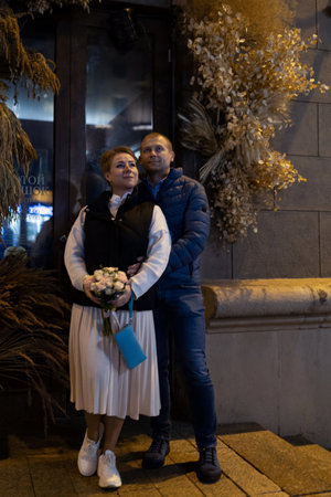 A married couple strolls through the city at night, enjoying the ambiance of the eveningの写真素材
