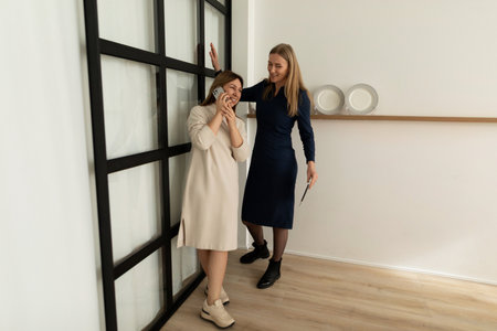 Friends enjoying a conversation in a modern indoor space during the afternoon