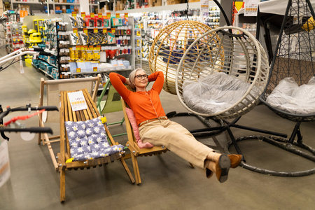 Middle-aged woman enjoying a shopping experience in a home improvement store with various product...