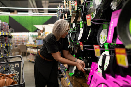 Mature woman shopping for household items in a large home improvement store