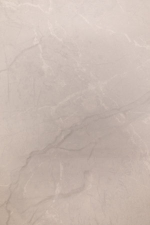 Close-up of smooth light gray marble surface with subtle patterns seen in indoor setting during daylight hoursの写真素材