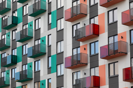 Modern high-rise apartment buildings showcasing vibrant facades and balconies in a bustling residential area ready for new tenantsの写真素材