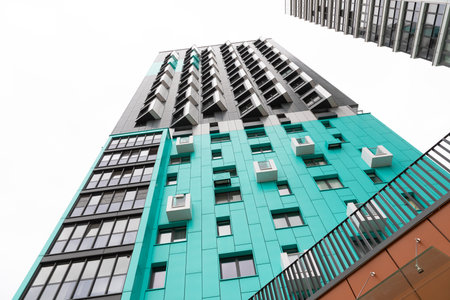 Modern high-rise apartment building in a vibrant residential area with rental options and property insurance considerationsの写真素材